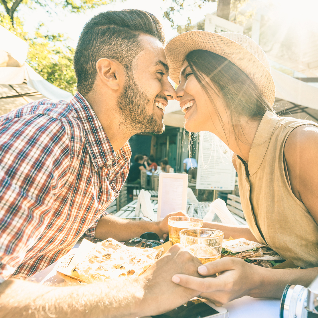 couple enjoying lunch together and leaning in for an eskimo kiss