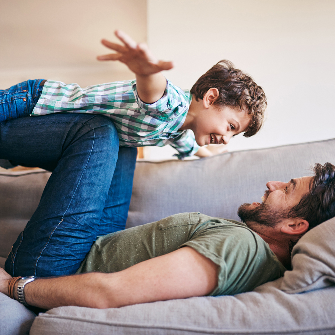 son flying on his dad's knees