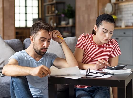 9-ways-to-pay-off-holiday-credit-card-debt-frustrated-couple-reviewing-bills