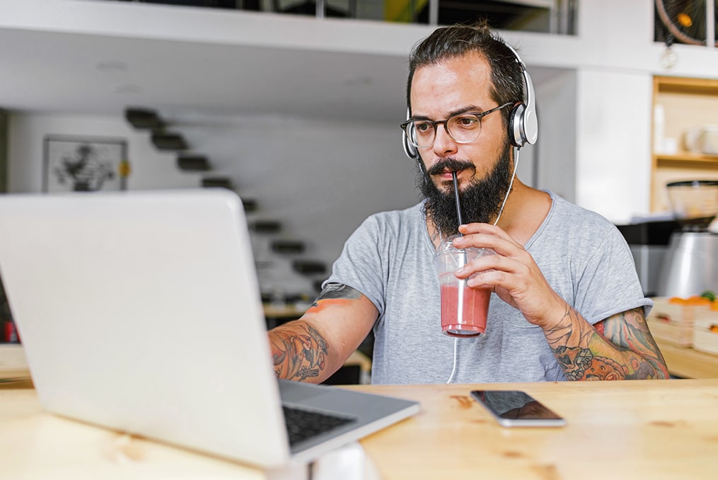 Loans 101—which loan is best for you-main with beard drinking smoothly using laptop