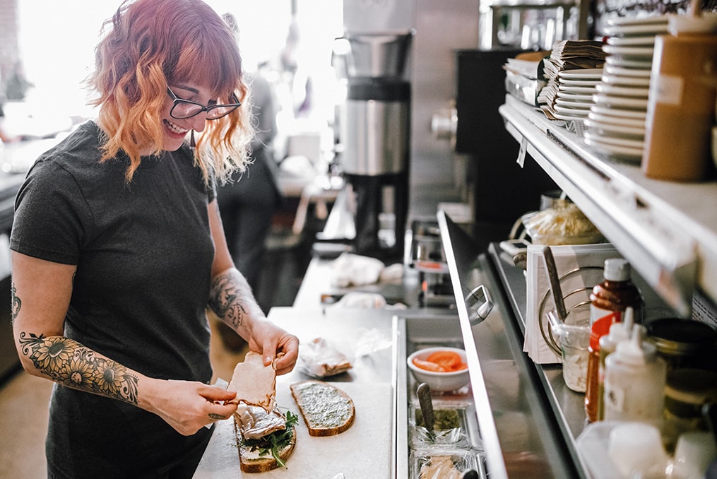 Loans 101—which loan is best for you-woman making sandwich at local small business