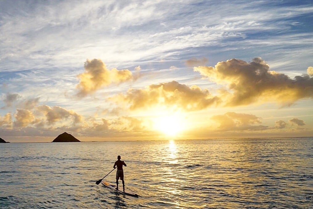 brian boehne paddle boarding into the sunset