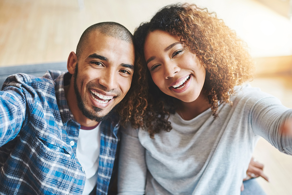 couple taking a selfie together smiling up at the camera