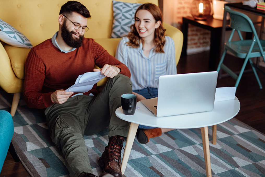 man smiling while looking over documents in modern style condo