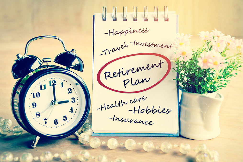 old fashion clock and notepad on a table - it is time to start thinking about your retirement