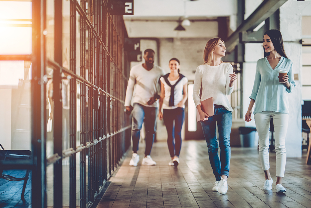 young professionals walking down an office hallway