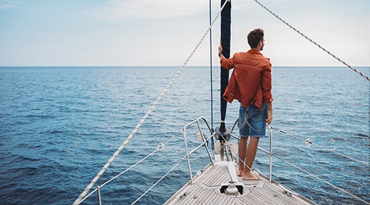 man on a boat looking at the view