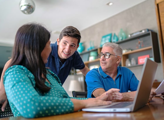 community giving-financial beginnings-teenage son and parents discussing finances at home