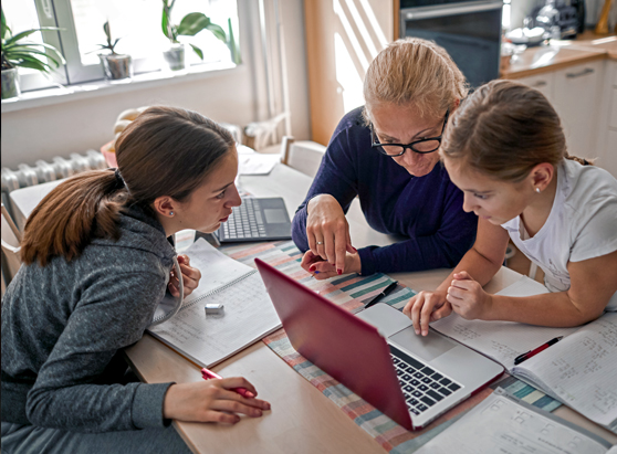 woman and her two daughters working together to learn more about money at home