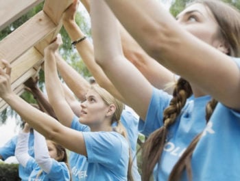 People helping build a house