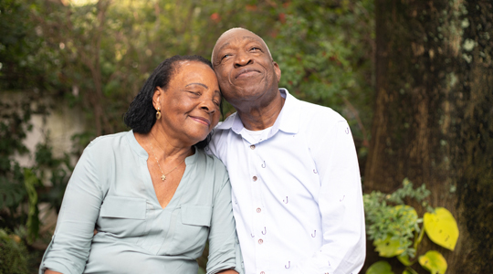 Older couple leaning on each other