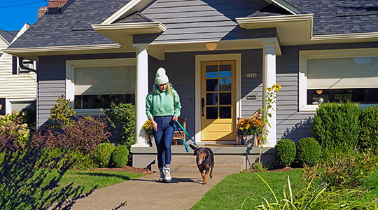 woman leaving home to walk her dog