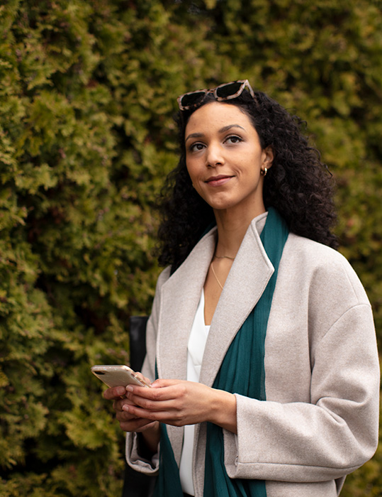 woman looking up from phone after confirming receipt of a wire in digital banking