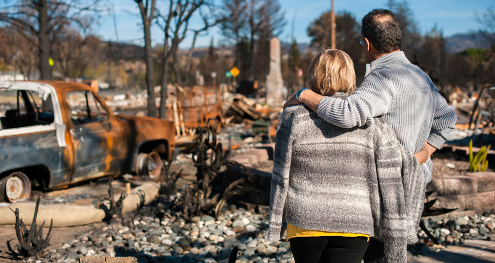 Emergency preparedness and disaster planning in the pacific northwest_family looking at aftermath of house fire_1015x540