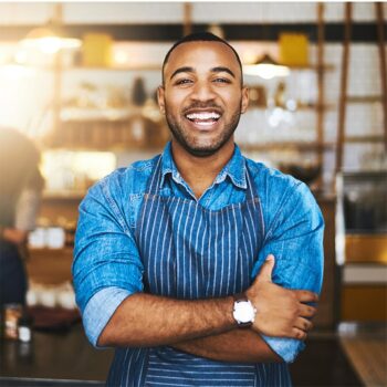 business owner smiling and crossing his hands