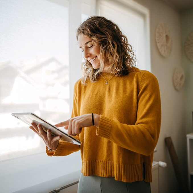 business woman using a digital tablet while working from home