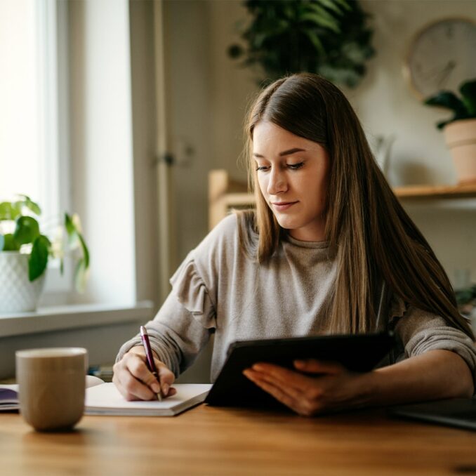 woman drinking coffee and using computer