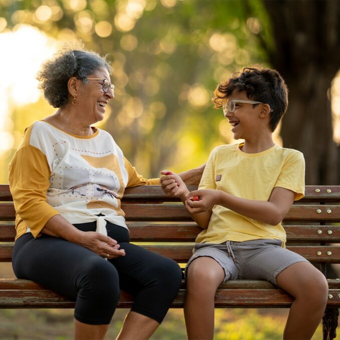 grandmother and grandson sitting on the bench
