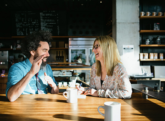 couple discussing and taking notes in cafe