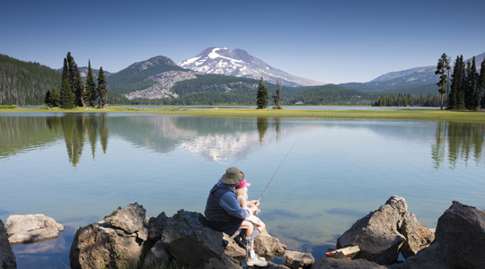 grandpa fishing with his grand-daughter near mt. jefferson
