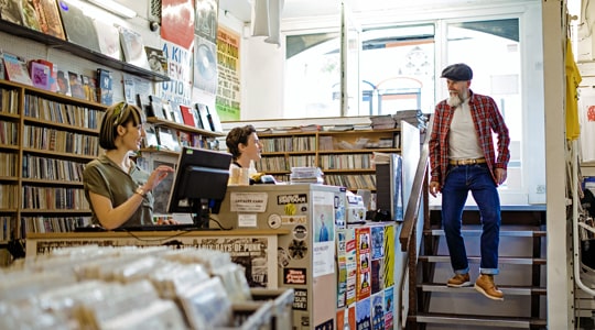 business merchant services-local record shop welcoming loyal customer