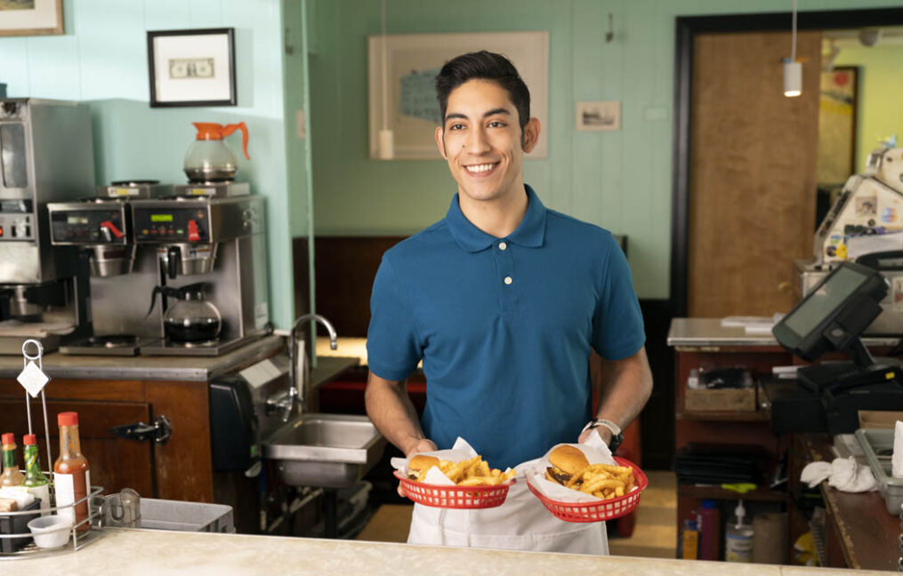 small business financing-employee serving burgers and fries at local small business diner