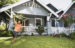 running child carrying glider in front yard