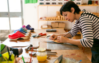 craftswoman in shoe workshop working