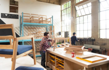 two men crafting chairs in a workshop