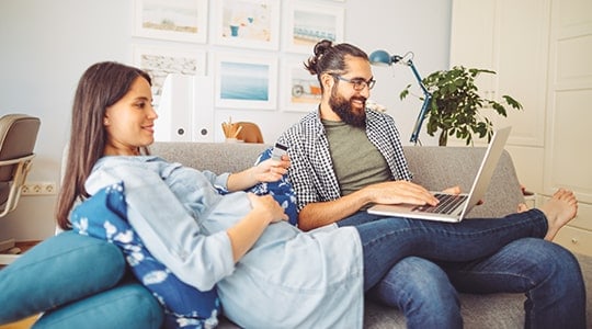 expecting couple on couch