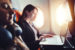 Woman sitting on a plane using her laptop.