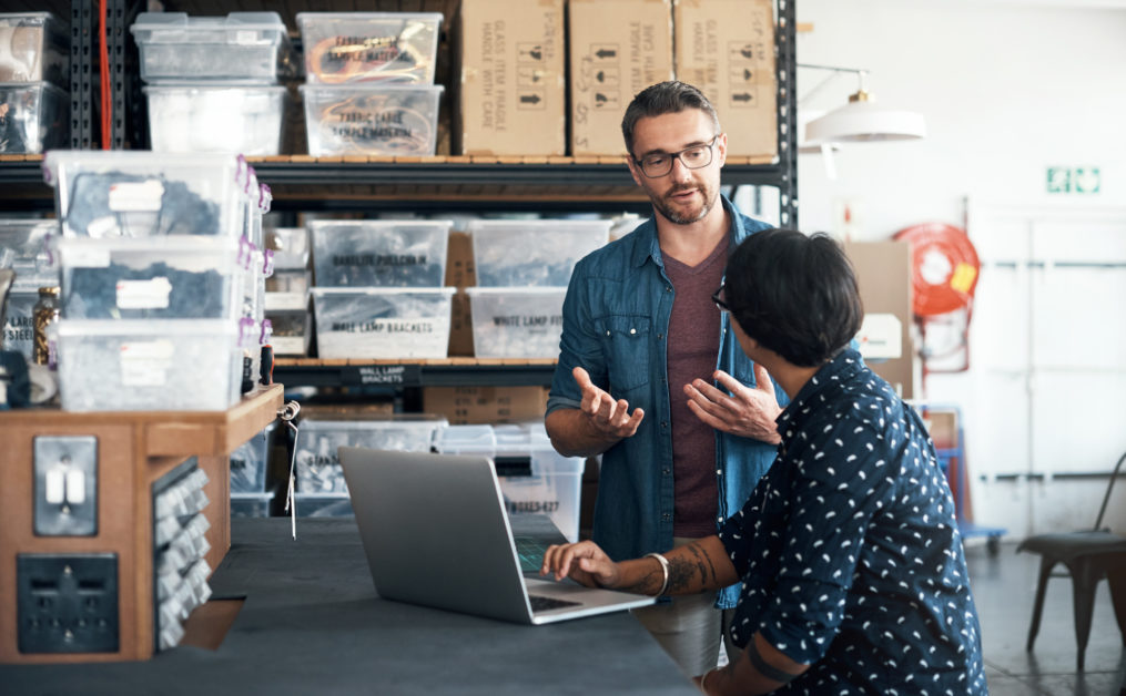 Shot of a man and woman having a discussion in a workshop