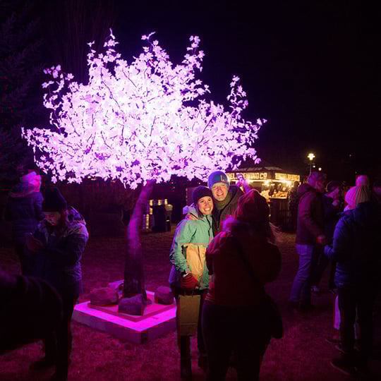 2022 Winterfest event attendees in front of a sparkle tree