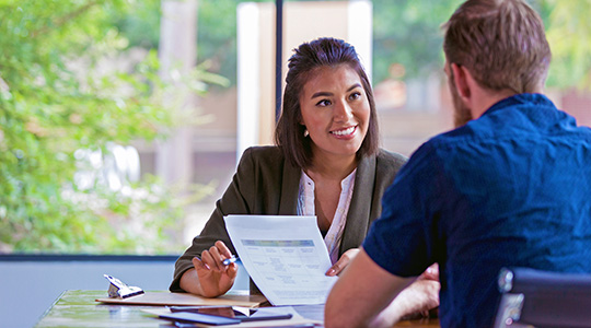 cheerful commercial relationship manager shares business loan information with member