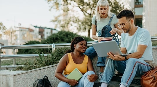 student resources-three students sharing laptop