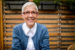 mature senior woman with trendy glasses and sweater smiling
