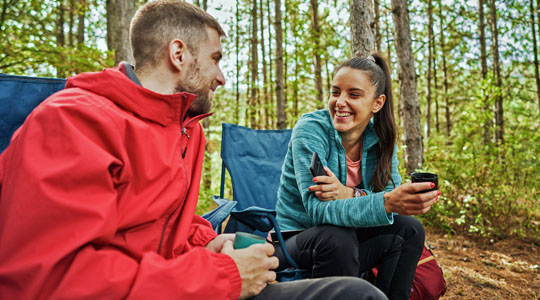 two young adults enjoying a campsite in the pacific northwest forest