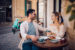 oung couple having brunch at traditional cafe in Europe