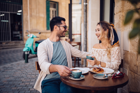 oung couple having brunch at traditional cafe in Europe