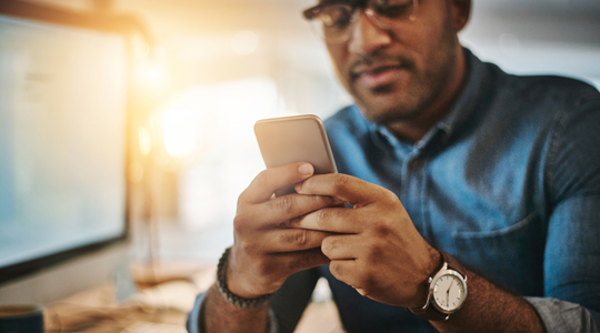 man looking at his mobile phone