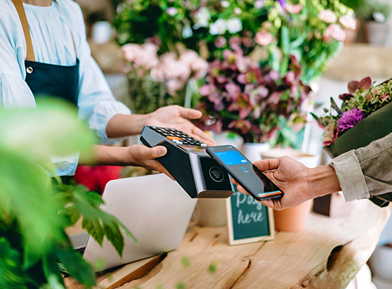 man paying with contactless option at flower shop